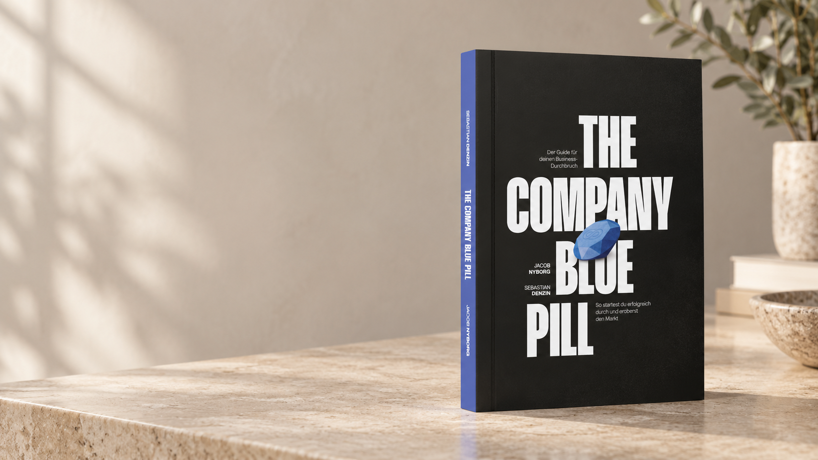 Company Blue Pill Hardcover auf einem Marmortisch